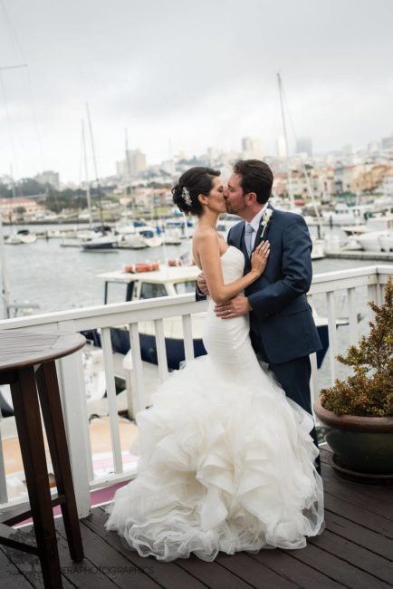 Kissing bride and groom at the marina